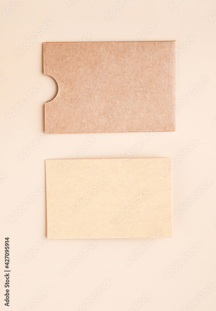Stylish branding mockup for displaying your artwork, business cards on craft paper. Recyclable material concept, eco-friendly manufacturing. Flat top view. High quality photo Stylish branding mockup for displaying your artwork, business cards on craft paper. Recyclable material concept, eco-friendly manufacturing. Flat top view. High quality photo