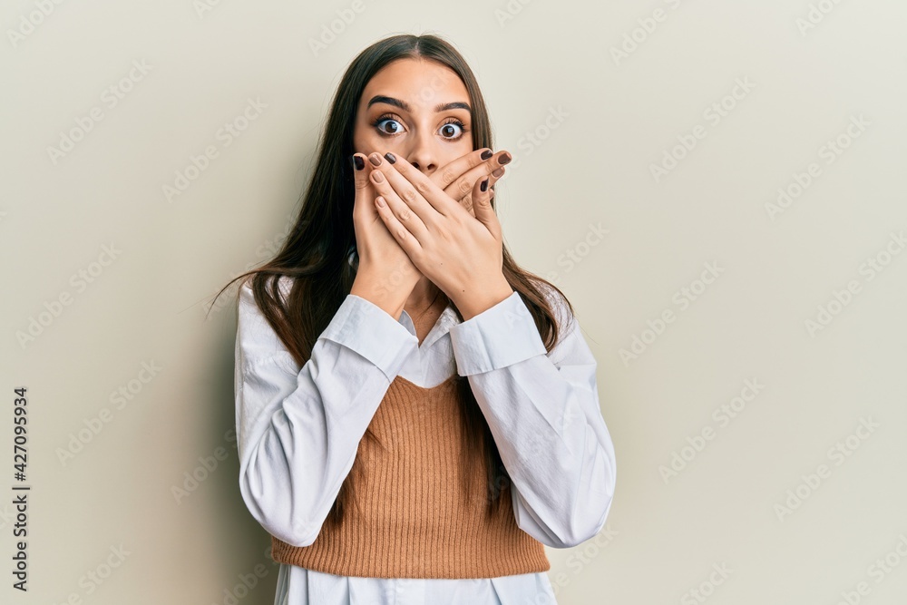 Beautiful brunette young woman wearing casual clothes shocked covering mouth with hands for mistake. secret concept. Beautiful brunette young woman wearing casual clothes shocked covering mouth with hands for mistake. secret concept.