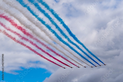 royal air force airshow team flying with red, white, and blue smoke 