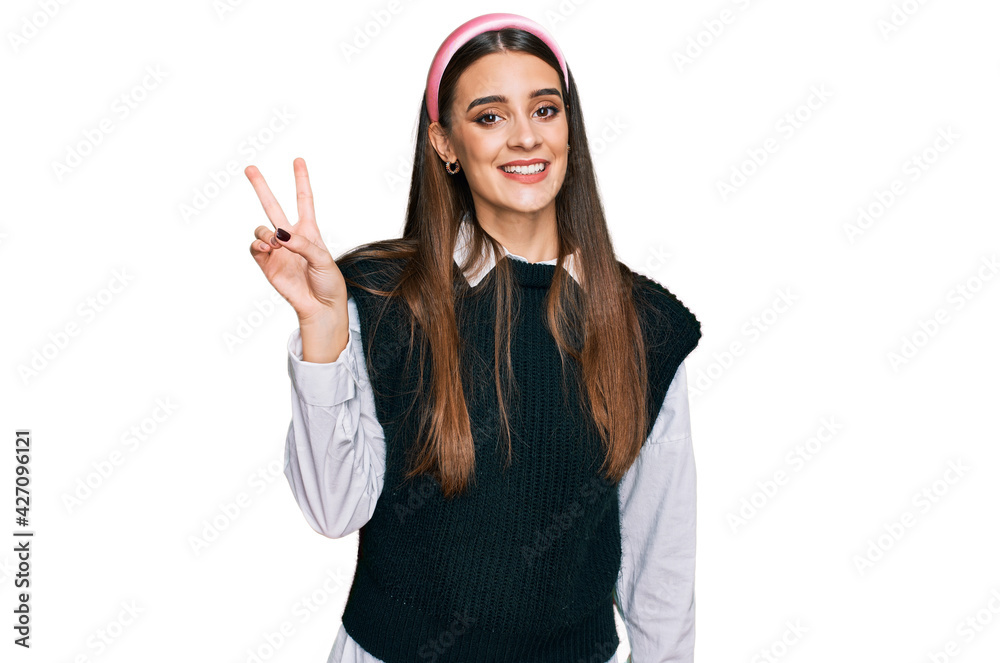 Young beautiful woman wearing casual white shirt showing and pointing up with fingers number two while smiling confident and happy. Young beautiful woman wearing casual white shirt showing and pointing up with fingers number two while smiling confident and happy.