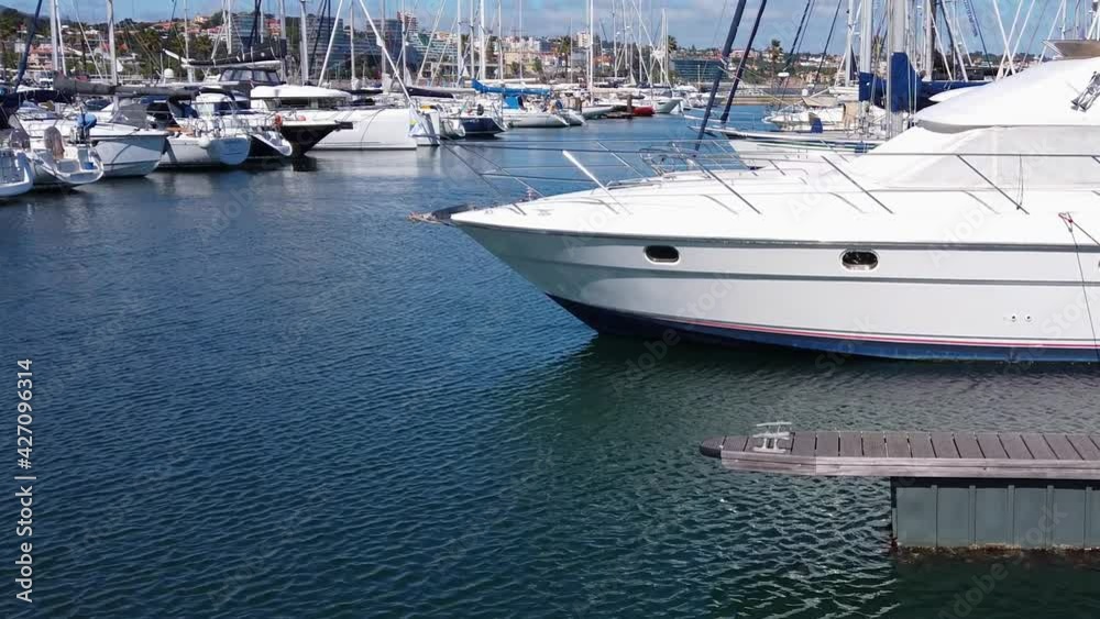Sailing boats and yachts in the marina during the day Sailing boats and yachts in the marina during the day