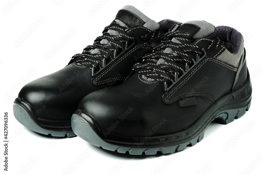 Pair of black leather work safety boots isolated on white. Industrial personal protective equipment. Individual protection means Pair of black leather work safety boots isolated on white. Industrial personal protective equipment. Individual protection means