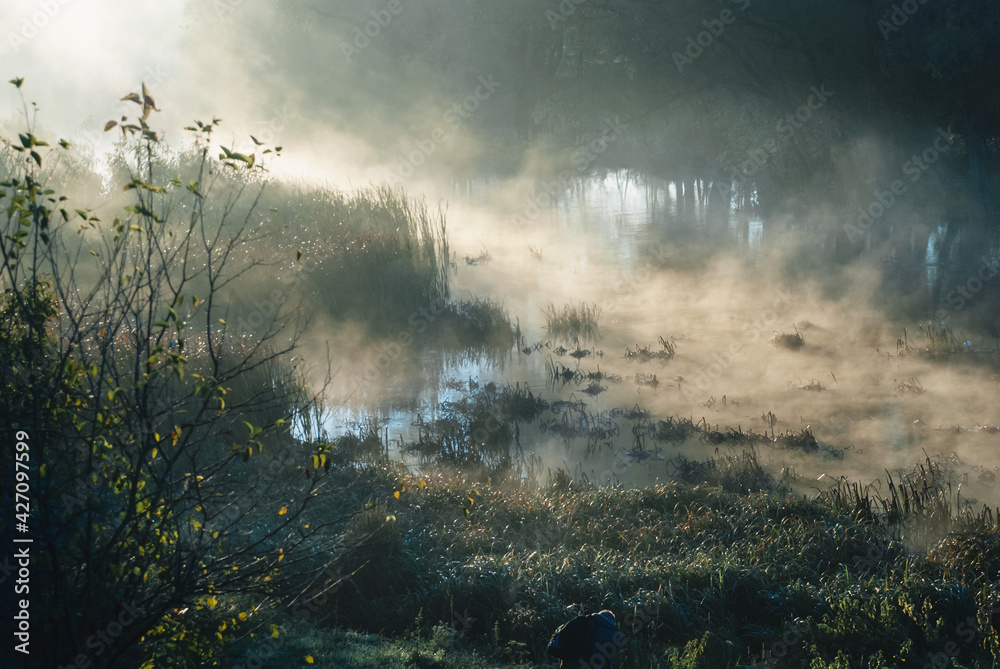 Mist and fog over the river, early morning, sun beams, sun rays on the water, mystery in the nature, morning magic. Mist and fog over the river, early morning, sun beams, sun rays on the water, mystery in the nature, morning magic.