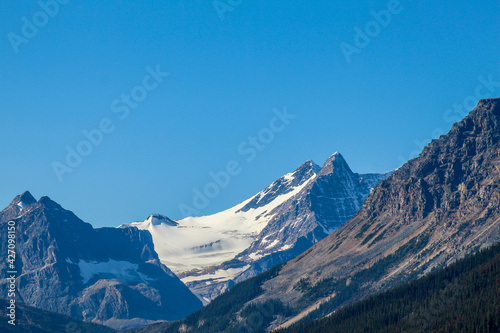 Snow capped mountains on sunny day with blue skies