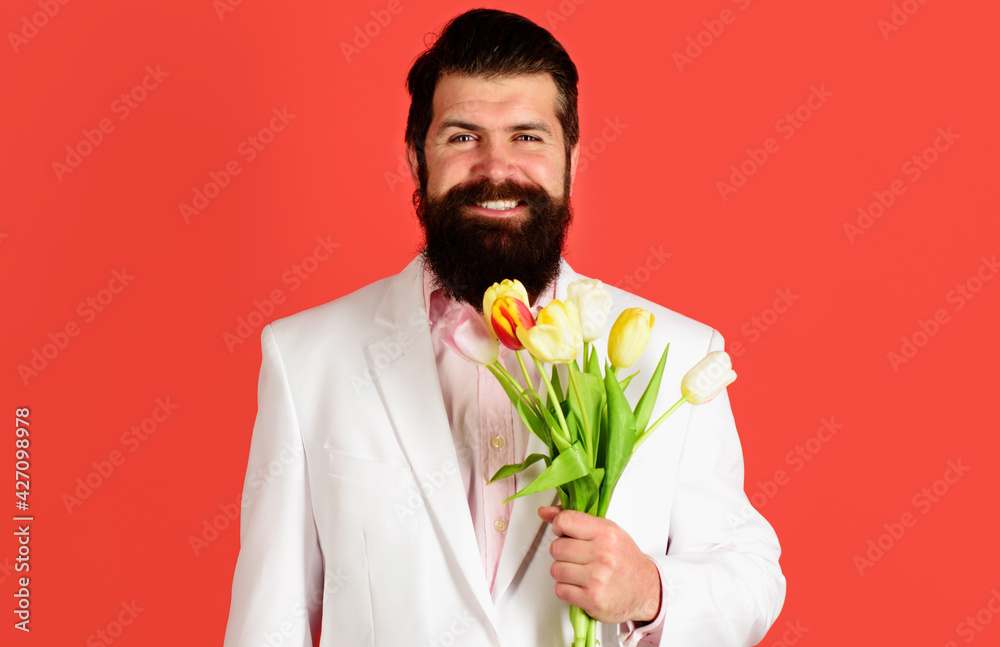 Handsome man with Bouquet of tulips. Businessman with flowers for birthday. Valentines Day. Womens Day. Handsome man with Bouquet of tulips. Businessman with flowers for birthday. Valentines Day. Womens Day.