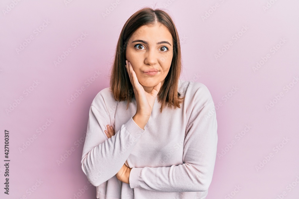 Young beautiful woman wearing casual clothes thinking looking tired and bored with depression problems with crossed arms. Young beautiful woman wearing casual clothes thinking looking tired and bored with depression problems with crossed arms.