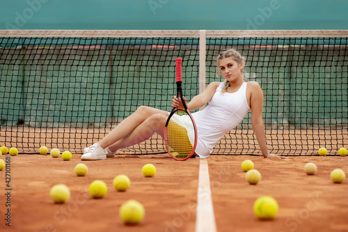 professional tennis player woman with racket and ball near net on court © volody10