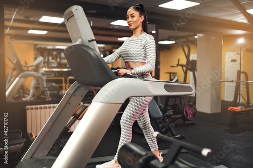 Young healthy woman cardio on a treadmill at the gym 
