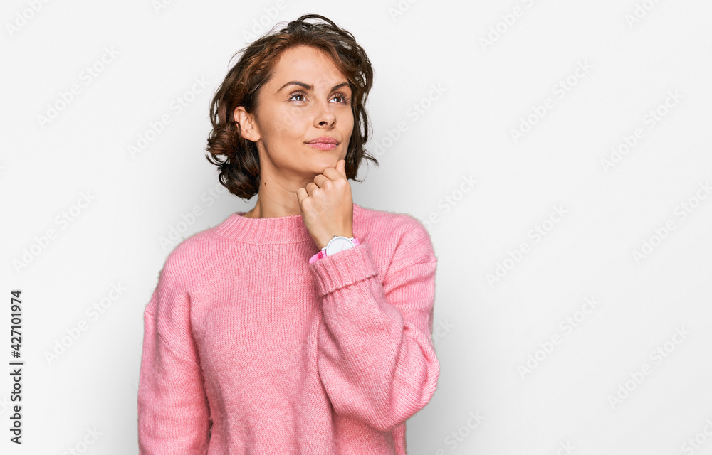 Young hispanic woman wearing casual clothes with hand on chin thinking about question, pensive expression. smiling and thoughtful face. doubt concept. Young hispanic woman wearing casual clothes with hand on chin thinking about question, pensive expression. smiling and thoughtful face. doubt concept.