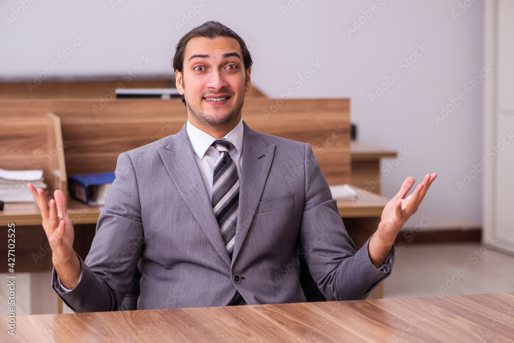 Young businessman employee sitting in the office Young businessman employee sitting in the office