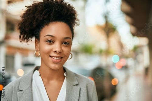 Young african american businesswoman smiling happy standing at the city.