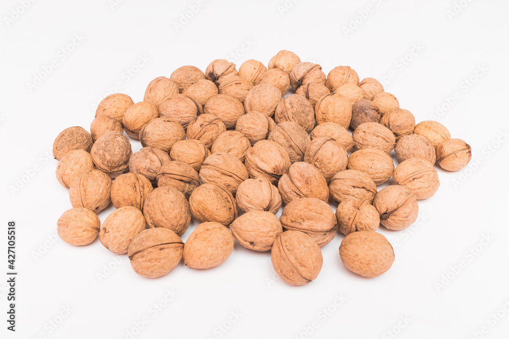 Heap of whole walnuts in the shell isolated on white background Heap of whole walnuts in the shell isolated on white background