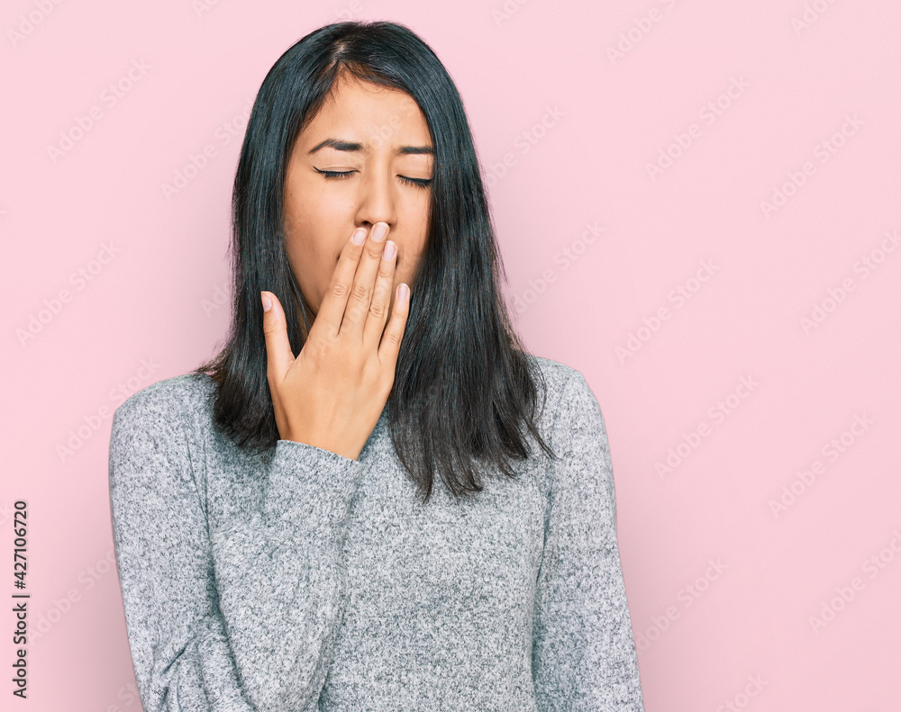 Beautiful asian young woman wearing casual clothes bored yawning tired covering mouth with hand. restless and sleepiness. Beautiful asian young woman wearing casual clothes bored yawning tired covering mouth with hand. restless and sleepiness.