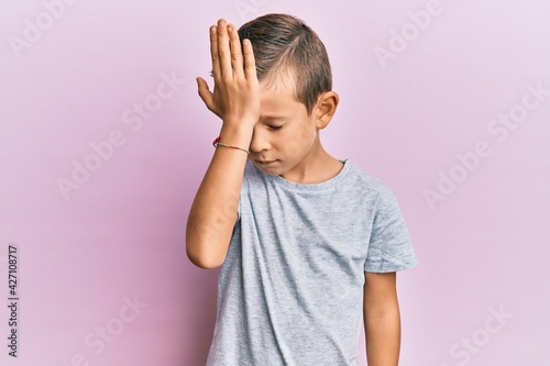 Adorable caucasian kid wearing casual clothes surprised with hand on head for mistake, remember error. forgot, bad memory concept.