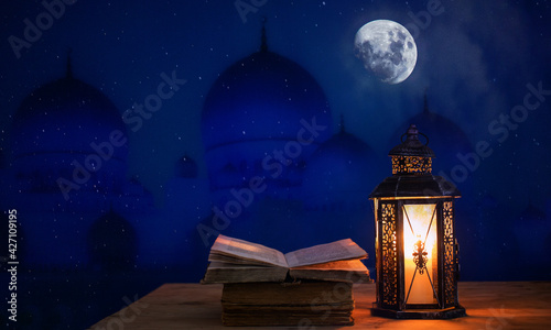 ramadan Kareem greeting photo with serene mosque background and beautiful glowing Arabic lantern