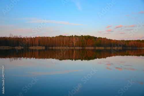 autumn forest reflecting in a calm, autumn lake