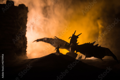 Battle between dragon and heroic soldiers. Creative table decoration. Selective focus