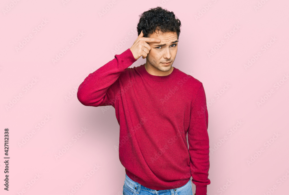 Young handsome man wearing casual clothes pointing unhappy to pimple on forehead, ugly infection of blackhead. acne and skin problem Young handsome man wearing casual clothes pointing unhappy to pimple on forehead, ugly infection of blackhead. acne and skin problem