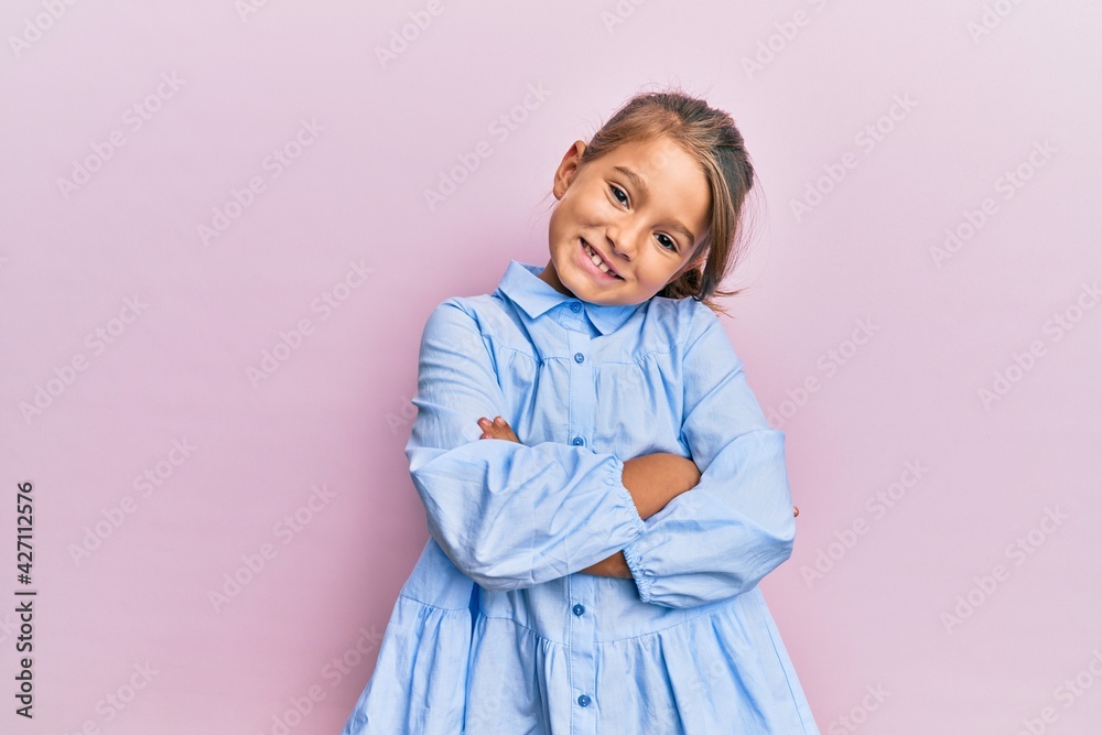 Little beautiful girl wearing casual clothes happy face smiling with crossed arms looking at the camera. positive person. Little beautiful girl wearing casual clothes happy face smiling with crossed arms looking at the camera. positive person.