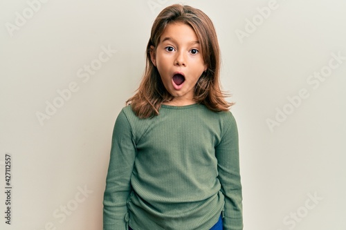 Little beautiful girl wearing casual clothes scared and amazed with open mouth for surprise, disbelief face photo