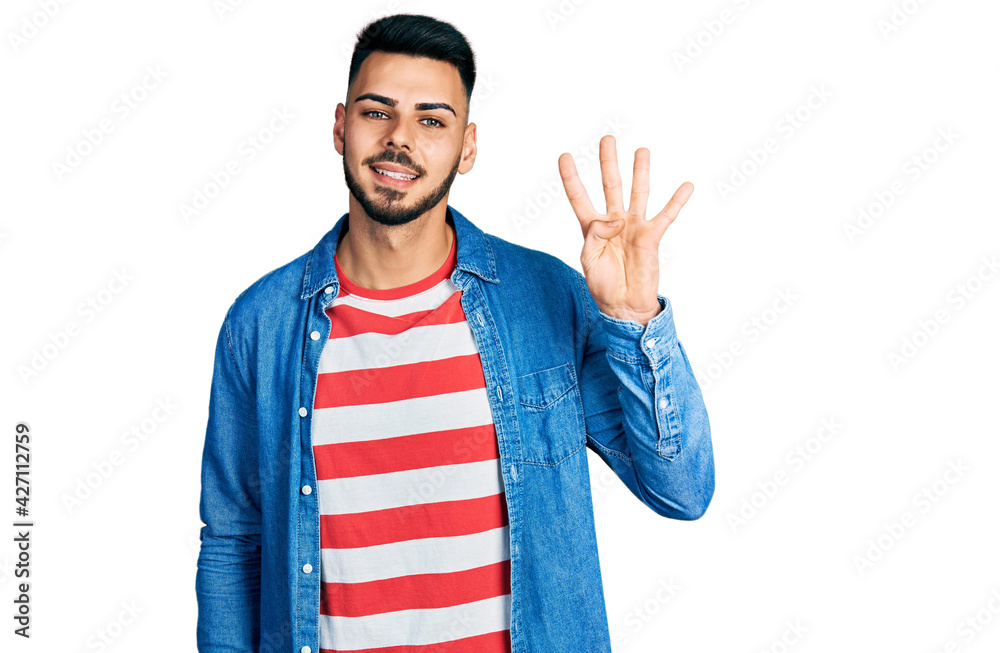 Young hispanic man with beard wearing casual denim jacket showing and pointing up with fingers number four while smiling confident and happy. Young hispanic man with beard wearing casual denim jacket showing and pointing up with fingers number four while smiling confident and happy.