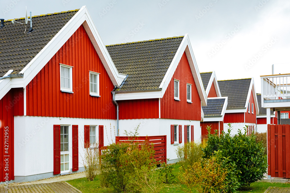 Red wooden houses in Sweden. Swedish houses on a street. Vacation in Sweden 