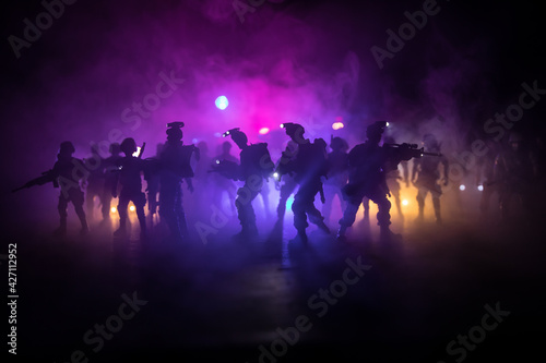 Anti-riot police give signal to be ready. Government power concept. Police in action. Smoke on a dark background with lights. Blue red flashing sirens. Dictatorship power © zef art