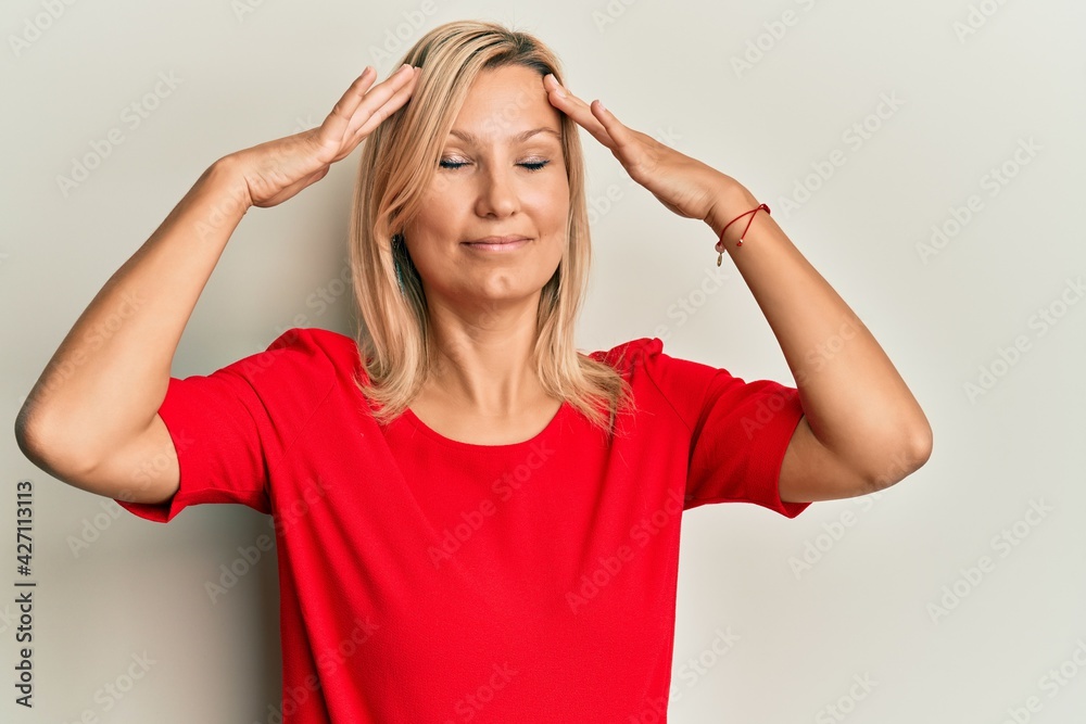 Middle age caucasian woman wearing casual clothes with hand on head, headache because stress. suffering migraine. Middle age caucasian woman wearing casual clothes with hand on head, headache because stress. suffering migraine.