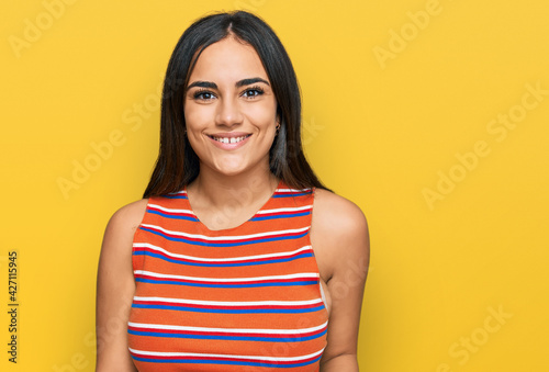 Young brunette woman wearing casual clothes with a happy and cool smile on face. lucky person.