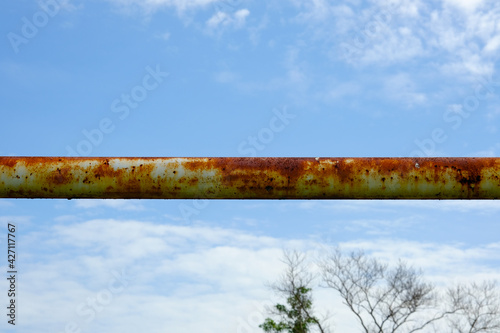 Selective focus picture of rusty and useless goalpost been put aside for field safety.
