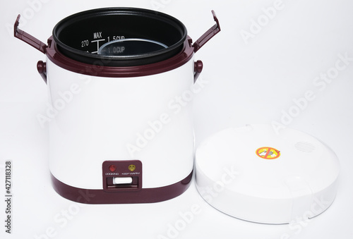 A picture of portable rice cooker open on isolated white background photo