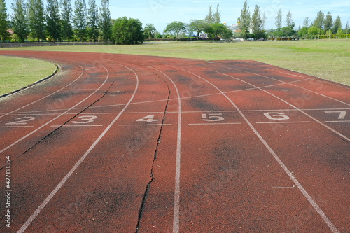 A picture of numbers on damage and ruin running track in the morning. No maintainance been done after the place been left 
