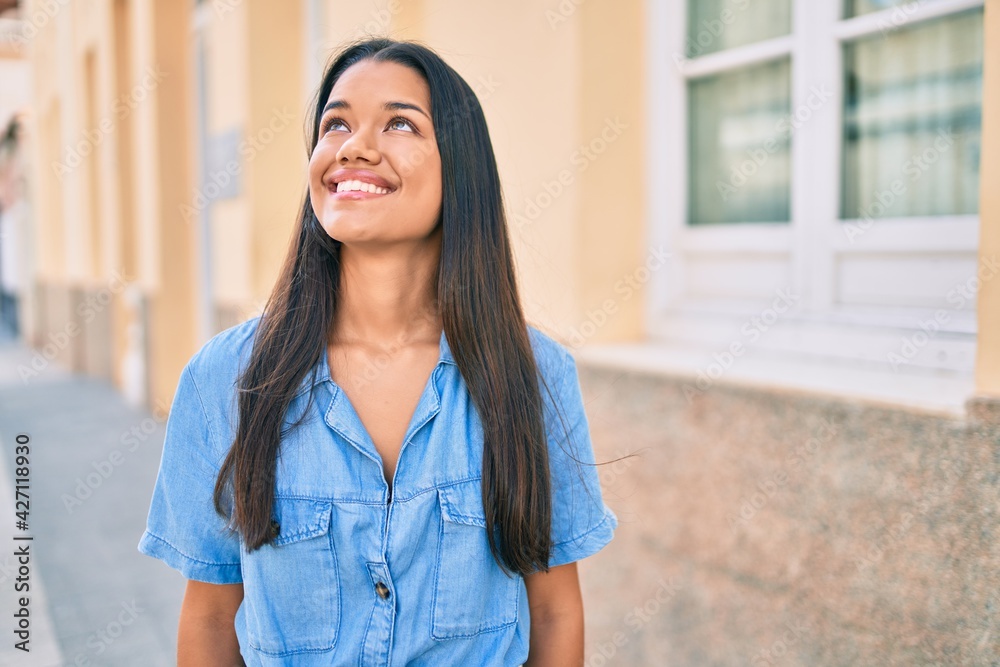 Young latin girl smiling happy walking at the city. Young latin girl smiling happy walking at the city.