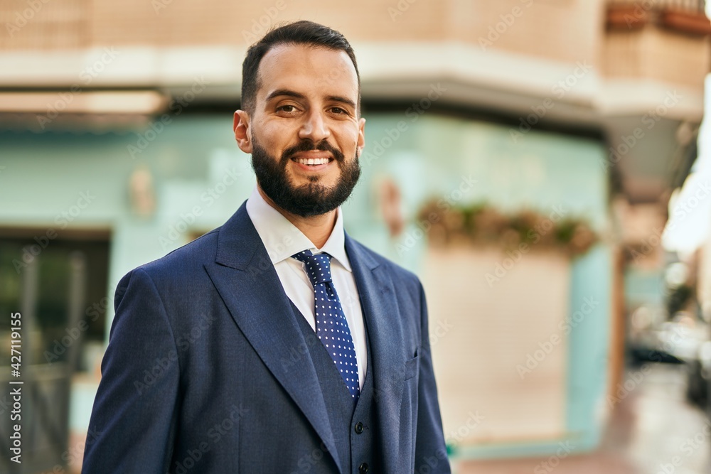 Young businessman smiling happy standing at the city.