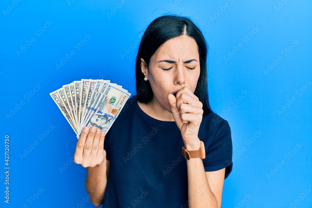 Beautiful young woman holding dollars feeling unwell and coughing as symptom for cold or bronchitis. health care concept. Beautiful young woman holding dollars feeling unwell and coughing as symptom for cold or bronchitis. health care concept.