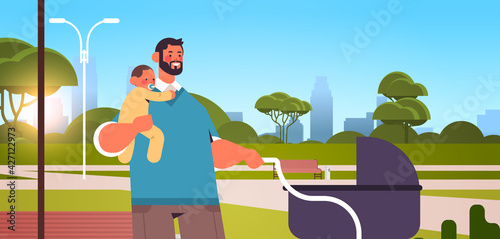father walking outdoor with little baby son fatherhood parenting concept dad spending time with his kid