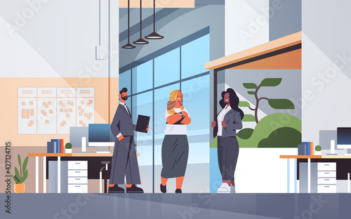 businesspeople discussing during meeting communication concept mix race colleagues standing together