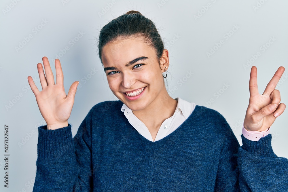 Young caucasian girl wearing casual clothes showing and pointing up with fingers number seven while smiling confident and happy. Young caucasian girl wearing casual clothes showing and pointing up with fingers number seven while smiling confident and happy.