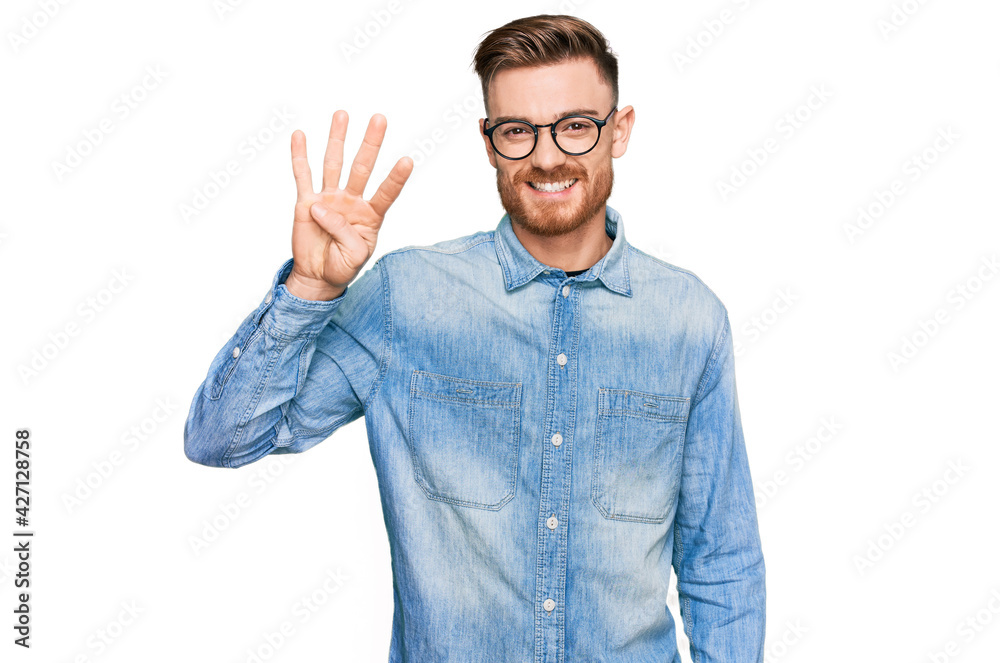 Young redhead man wearing casual denim shirt showing and pointing up with fingers number four while smiling confident and happy. Young redhead man wearing casual denim shirt showing and pointing up with fingers number four while smiling confident and happy.