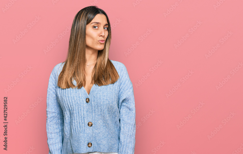 Fototapeta premium Young woman wearing casual clothes looking at the camera blowing a kiss on air being lovely and sexy. love expression.