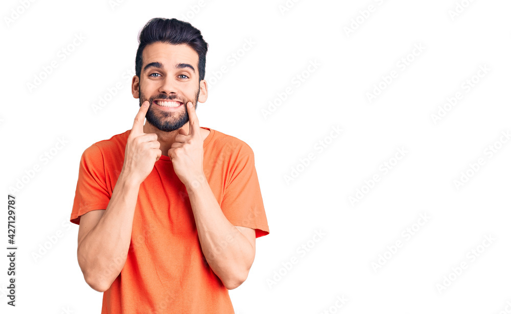 Young handsome man with beard wearing casual t-shirt smiling with open mouth, fingers pointing and forcing cheerful smile Young handsome man with beard wearing casual t-shirt smiling with open mouth, fingers pointing and forcing cheerful smile