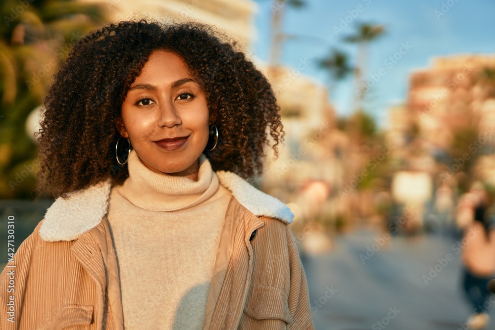 Young african american woman smiling happy standing at the city. Young african american woman smiling happy standing at the city.