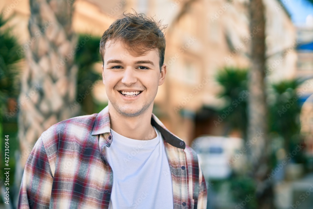 Young caucasian man smiling happy standing at the city. Young caucasian man smiling happy standing at the city.