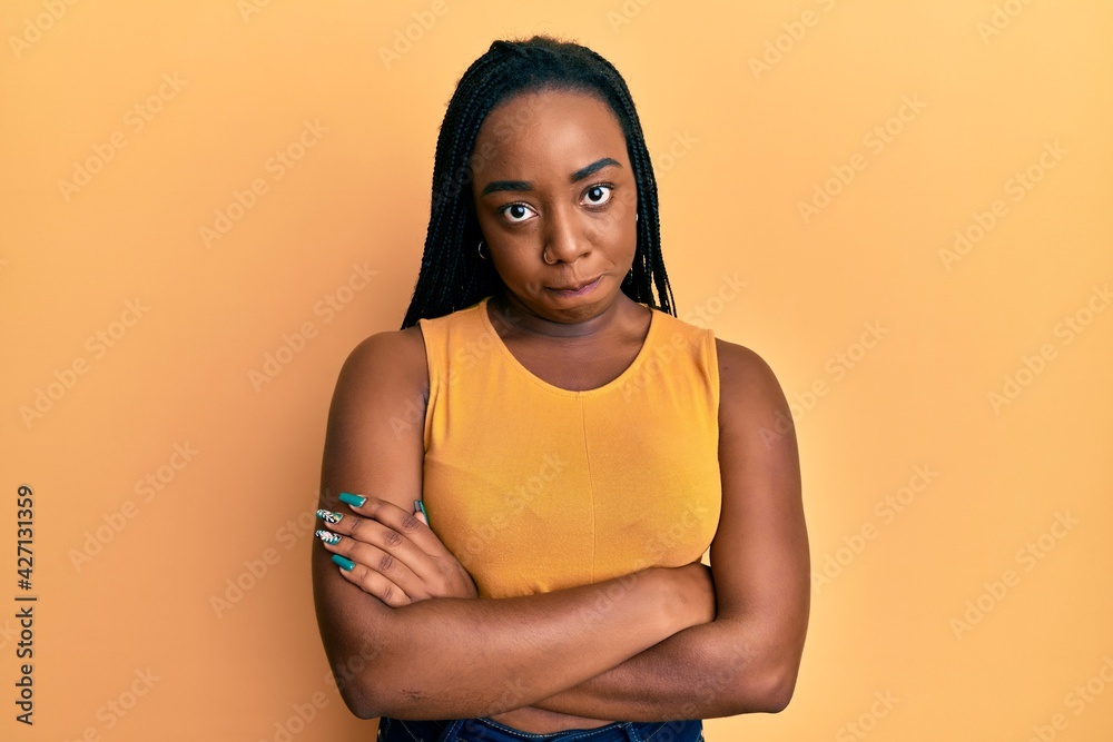 Obraz premium Young african american woman with arms crossed gesture skeptic and nervous, frowning upset because of problem. negative person.