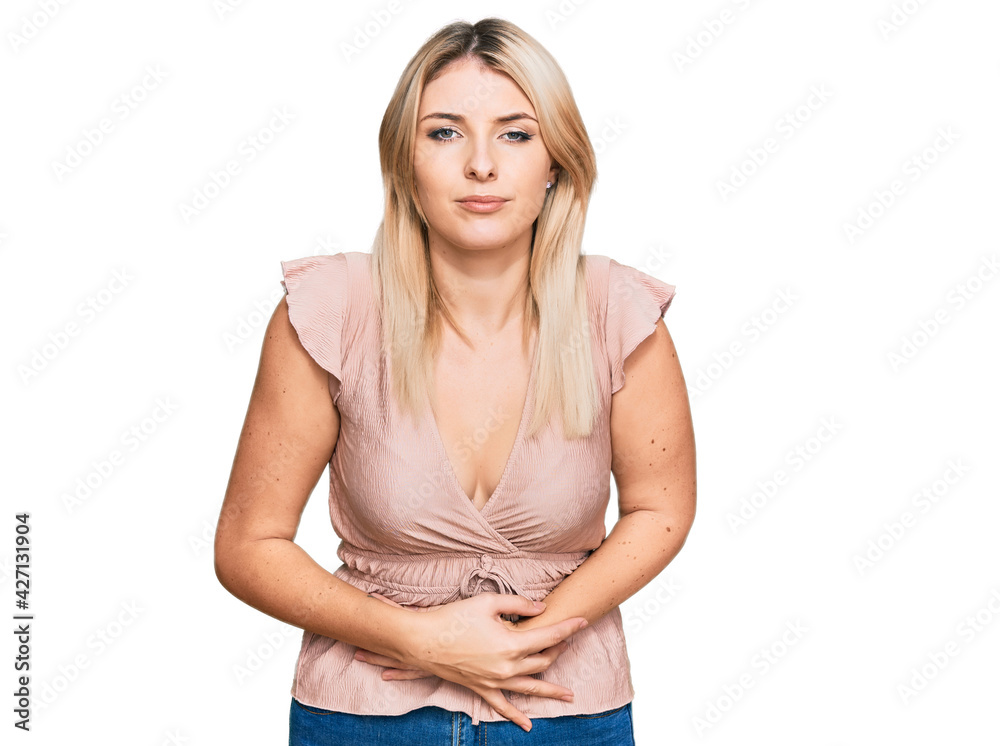 Young caucasian woman wearing casual clothes with hand on stomach because indigestion, painful illness feeling unwell. ache concept. Young caucasian woman wearing casual clothes with hand on stomach because indigestion, painful illness feeling unwell. ache concept.