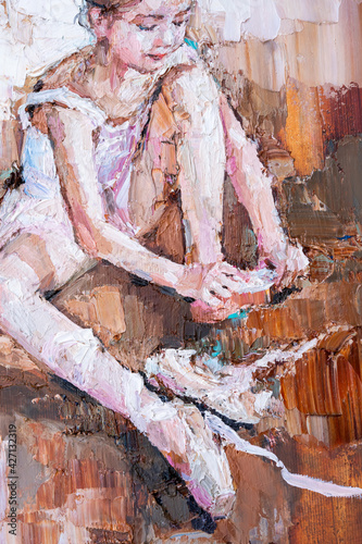 Fototapeta Naklejka Na Ścianę i Meble -  Little ballerina  sits and fastens pointe shoes on a light brown background. Fragment of oil painting, palette knife technique and brush. .Little girl in a dance class.