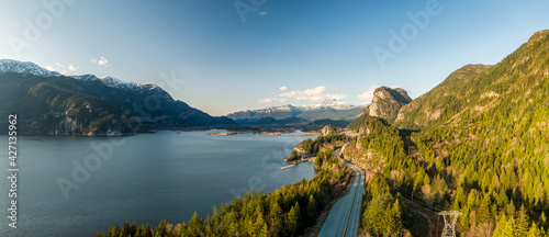 Aerial panoramic view of Sea to Sky Highway with Chief Mountain in the background. Sunny Spring Season. Taken near Squamish, North of Vancouver, British Columbia, Canada.