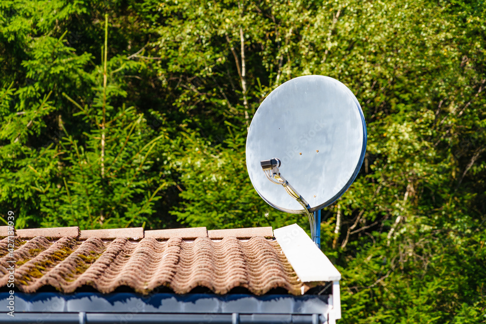 Satellite dish on roof of house