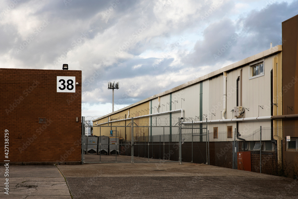 Industrial driveway dormant during business closures. - obrazy, fototapety, plakaty 