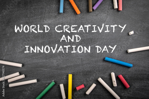 World Creativity and Innovation Day on 21 April. Colored pieces of chalk on a dark chalk board